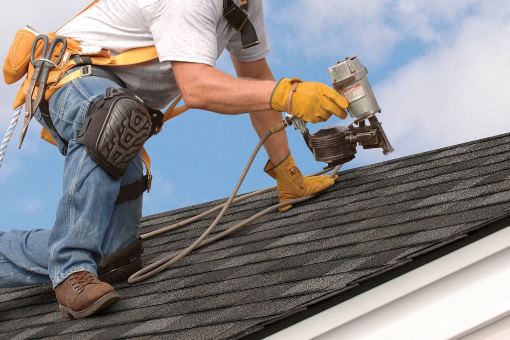 Licensed roofing contractor working on roof